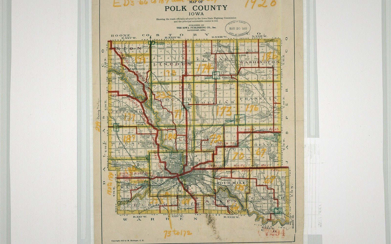 A framed county road map hanging on a wall