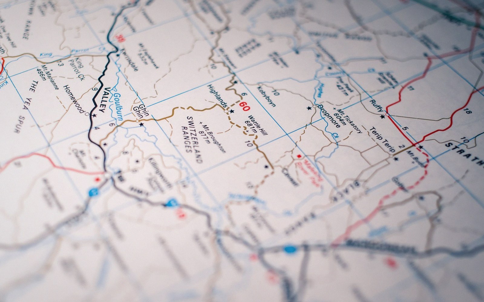 A road map in shallow focus with marker pins set into it