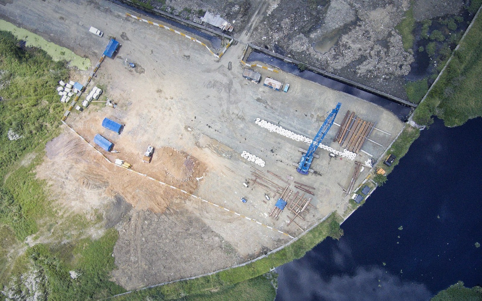 An oblique aerial view of a worked site beside water