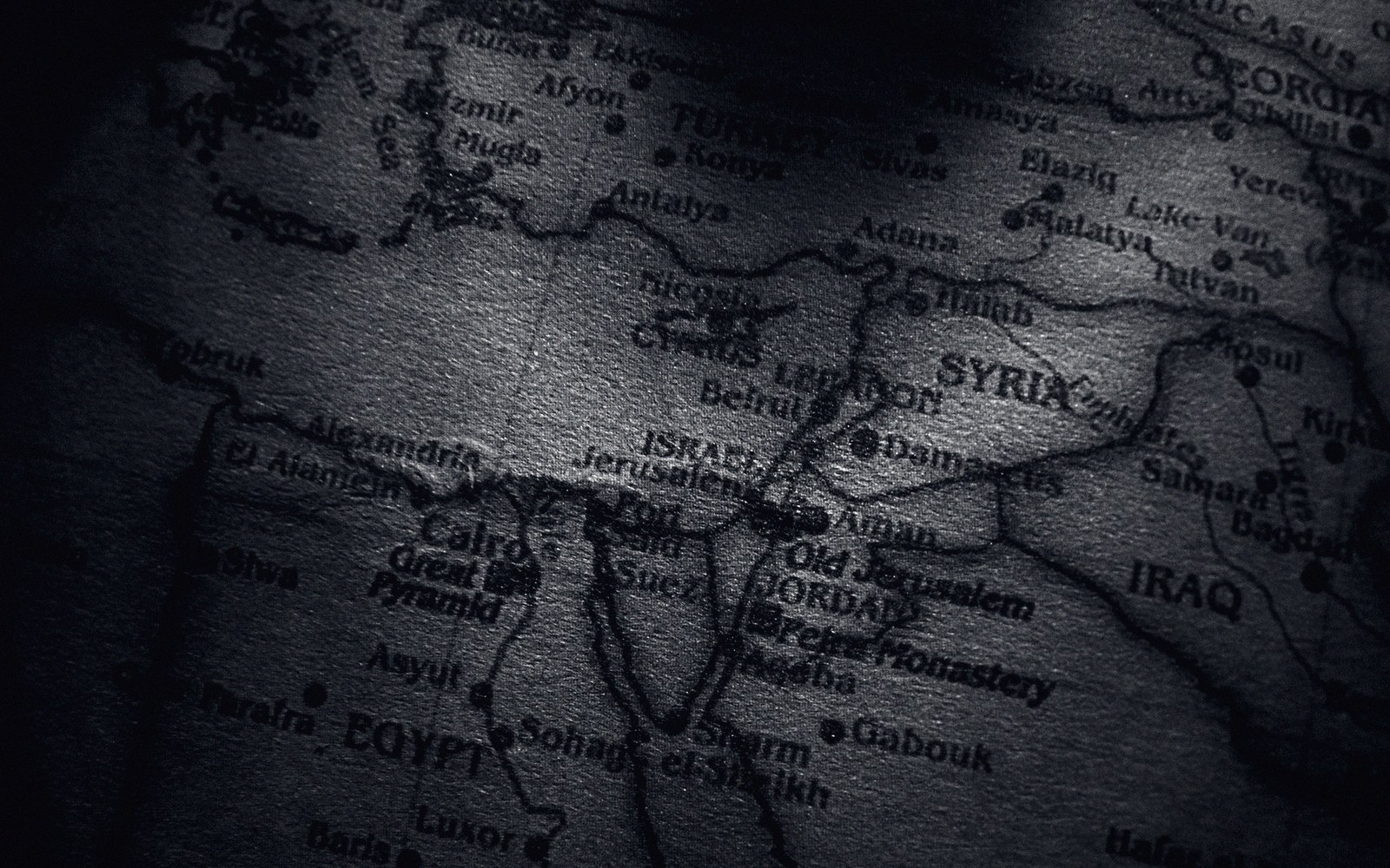 A close detail of an old atlas plate in low light